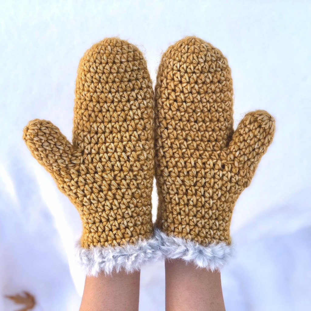 finished crochet mittens with faux fur accents on the wrist