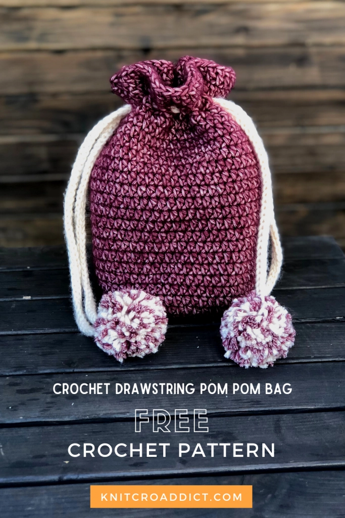 finished crochet drawstring bag with pom pom accents